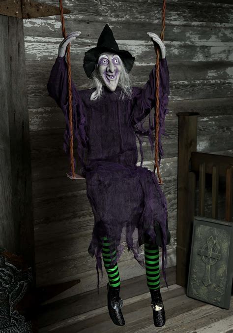 Turn your front porch into a hauntingly beautiful sight with swinging witch spirot Halloween displays